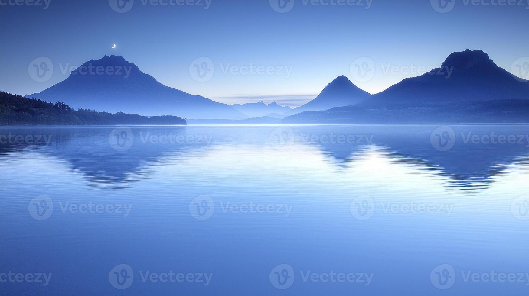A mountain range is reflected in a lake photo