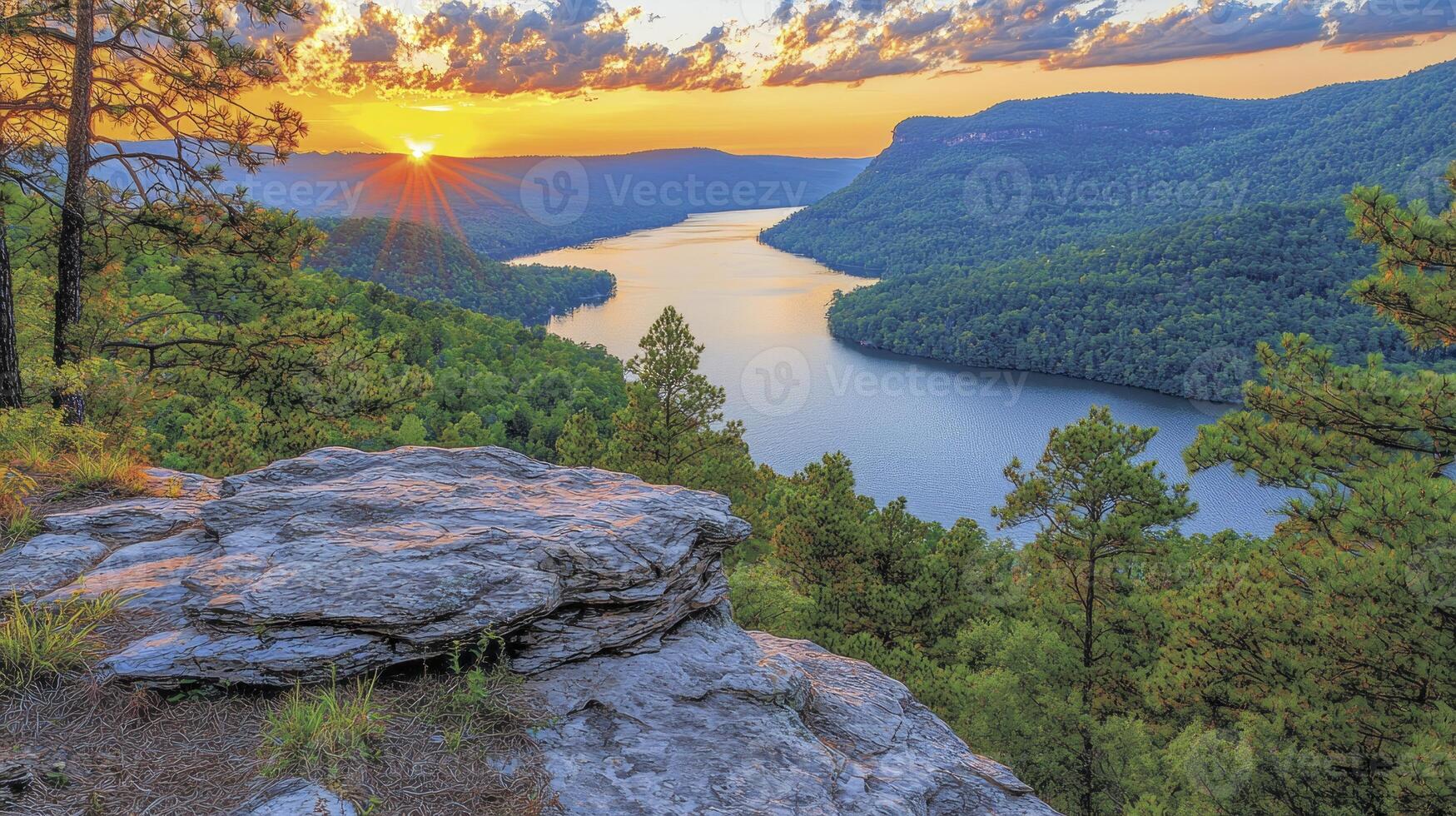The sun sets over a lake surrounded by trees photo