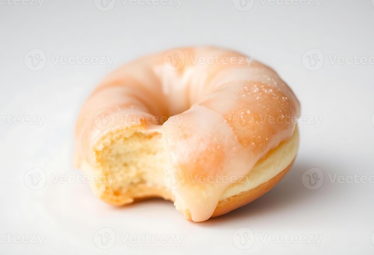 glazed donut with a bite taken out of it photo