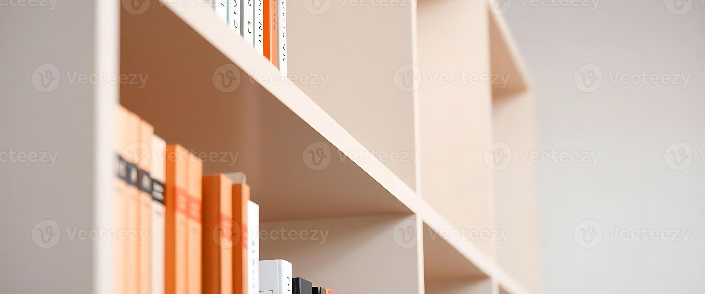 row of books sitting on top of a white shelf photo