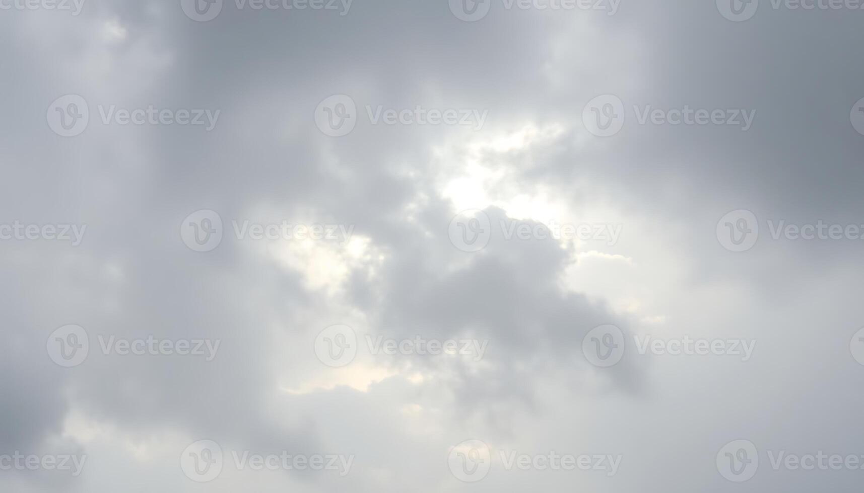group of people standing on top of a beach under a cloudy sky photo