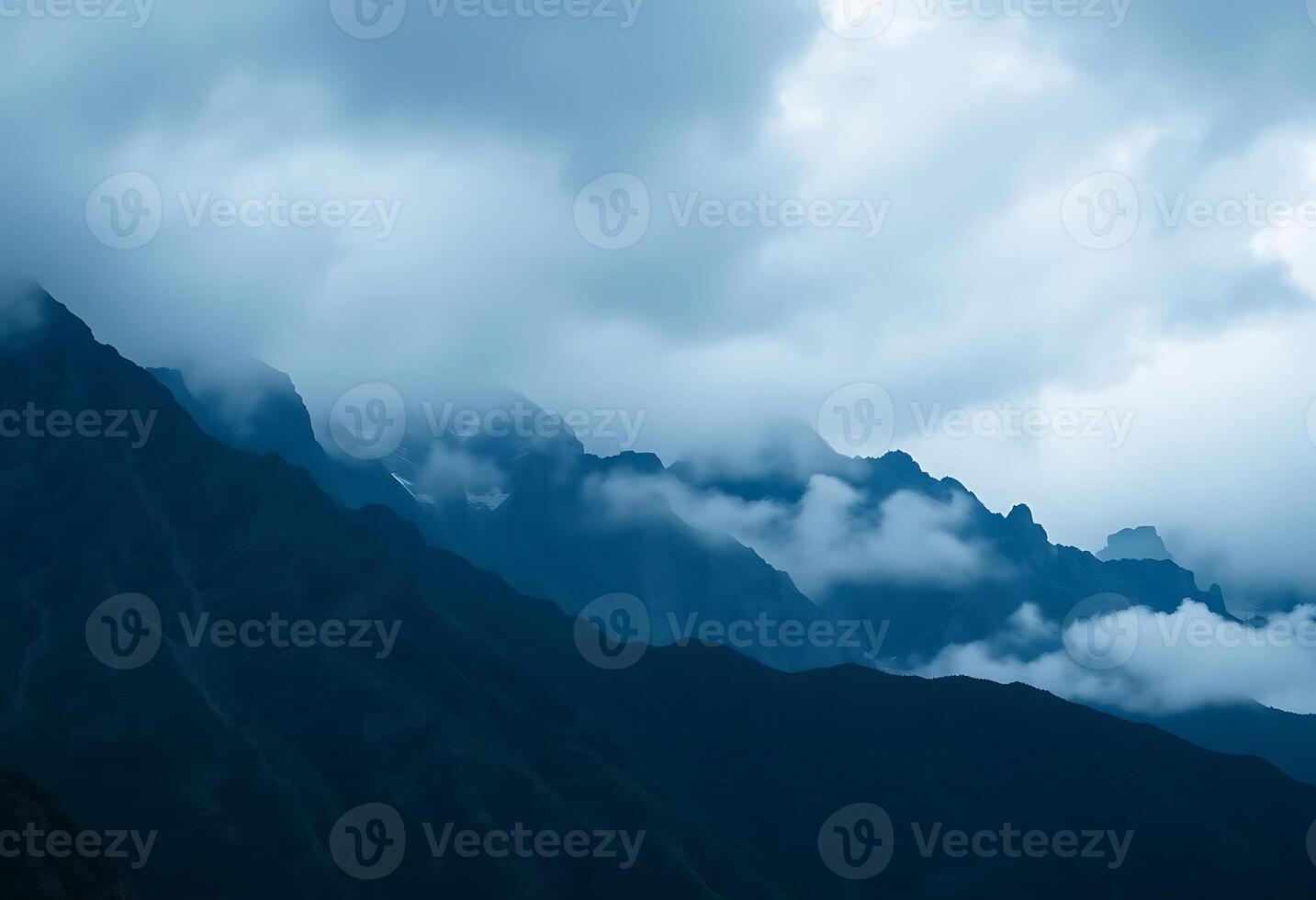 view of a mountain range with clouds in the sky photo