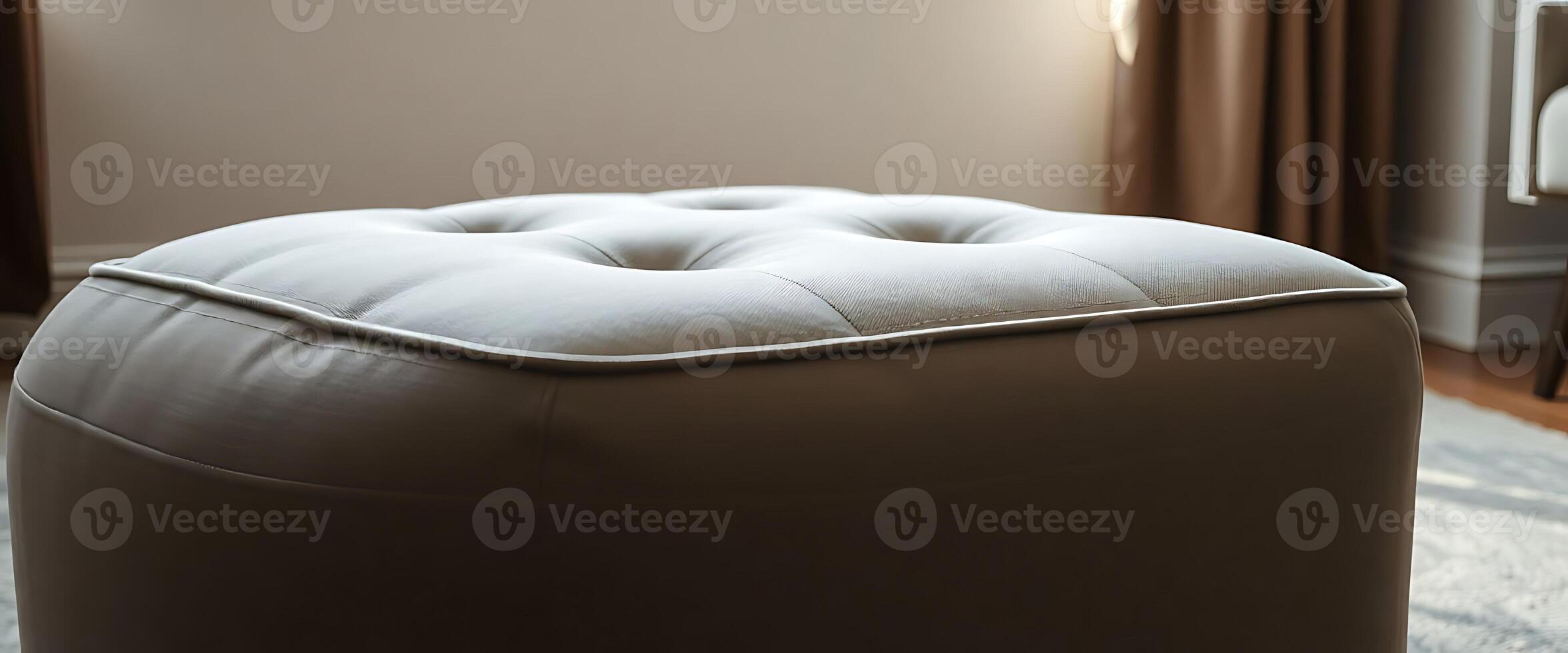 white ottoman sitting on top of a rug in a living room photo