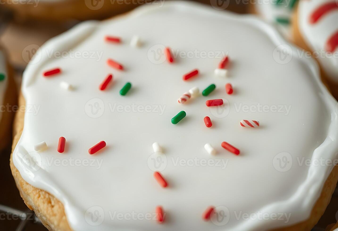 close up of a frosted cookie with sprinkles photo