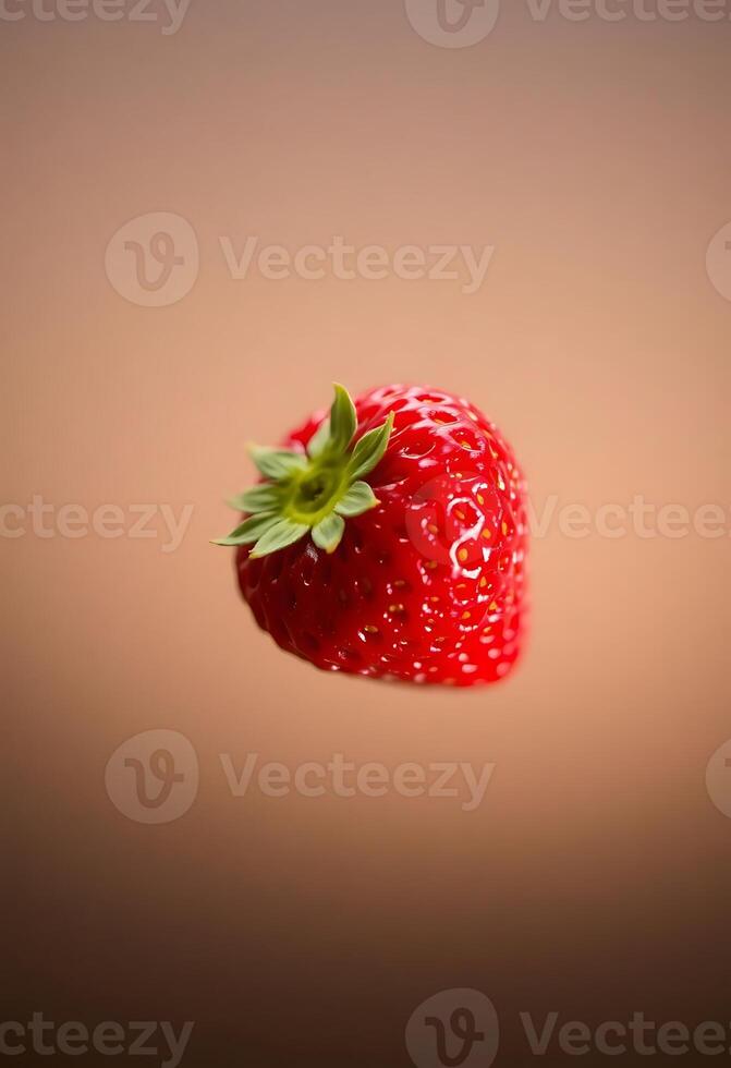 red strawberry with a green stem floating in the air photo