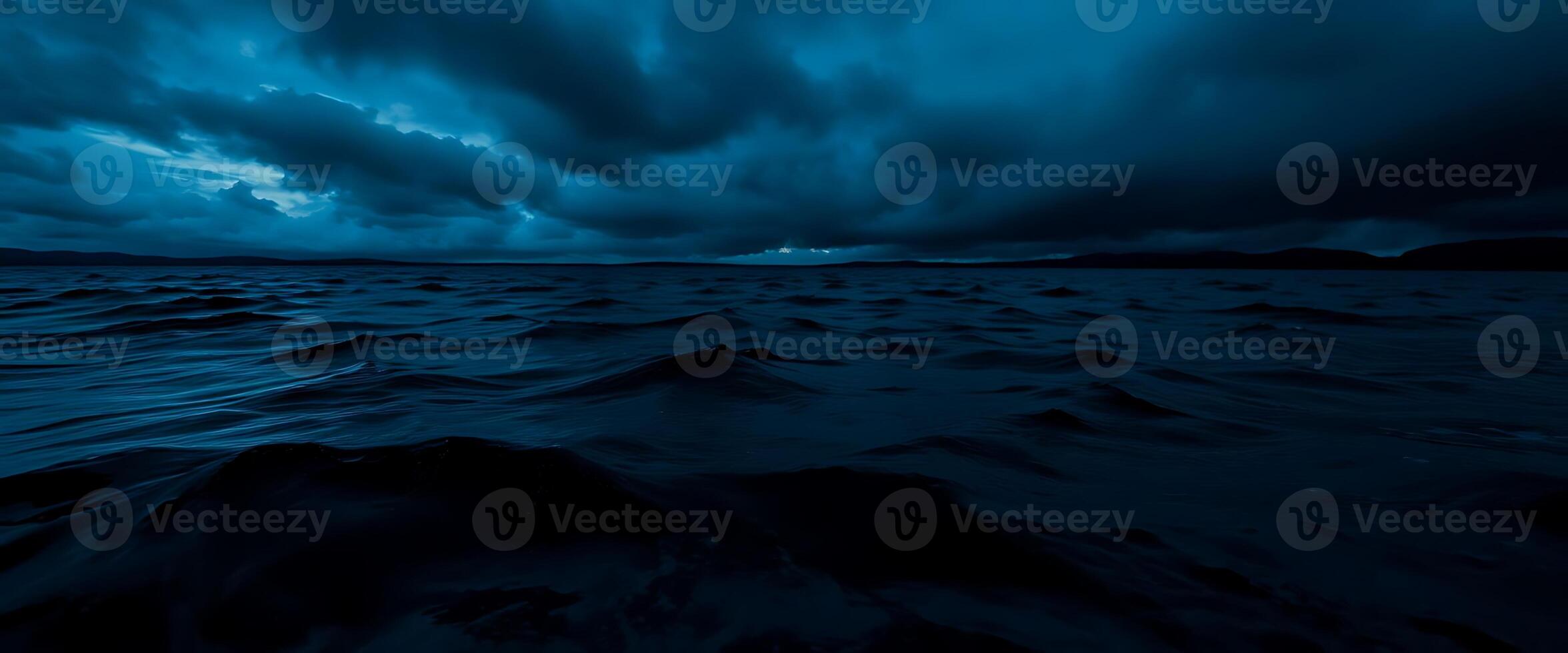 large body of water under a cloudy sky photo