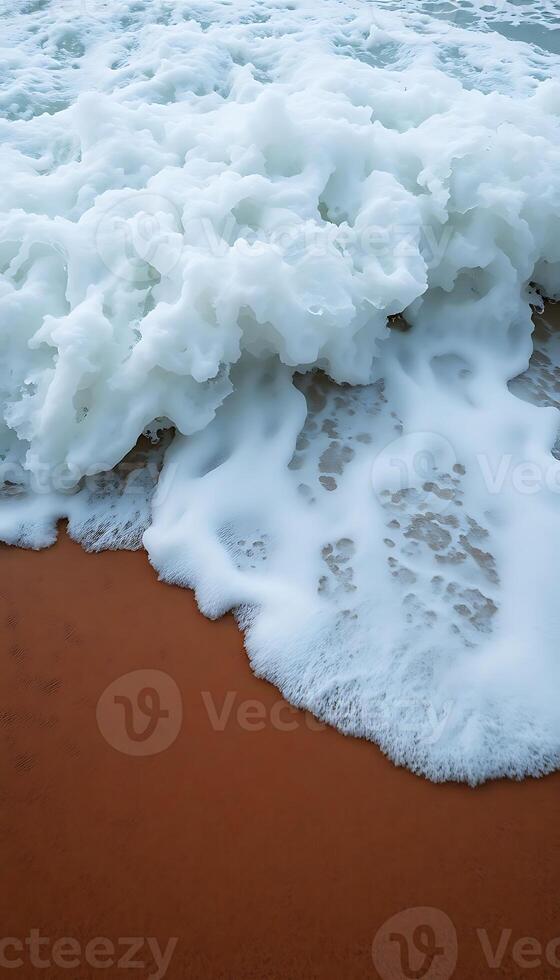 close up of a wave on a sandy beach photo