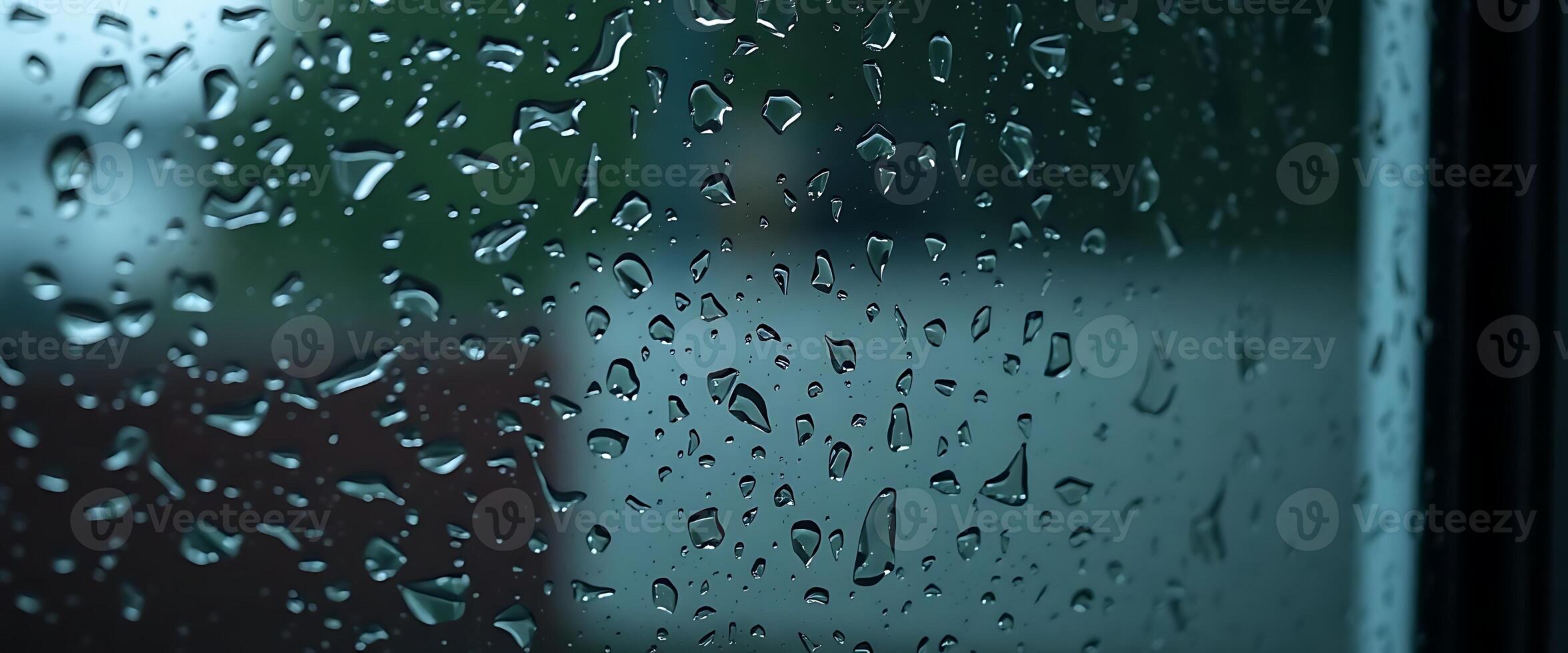 rain drops on a window with a blurry building in the background photo