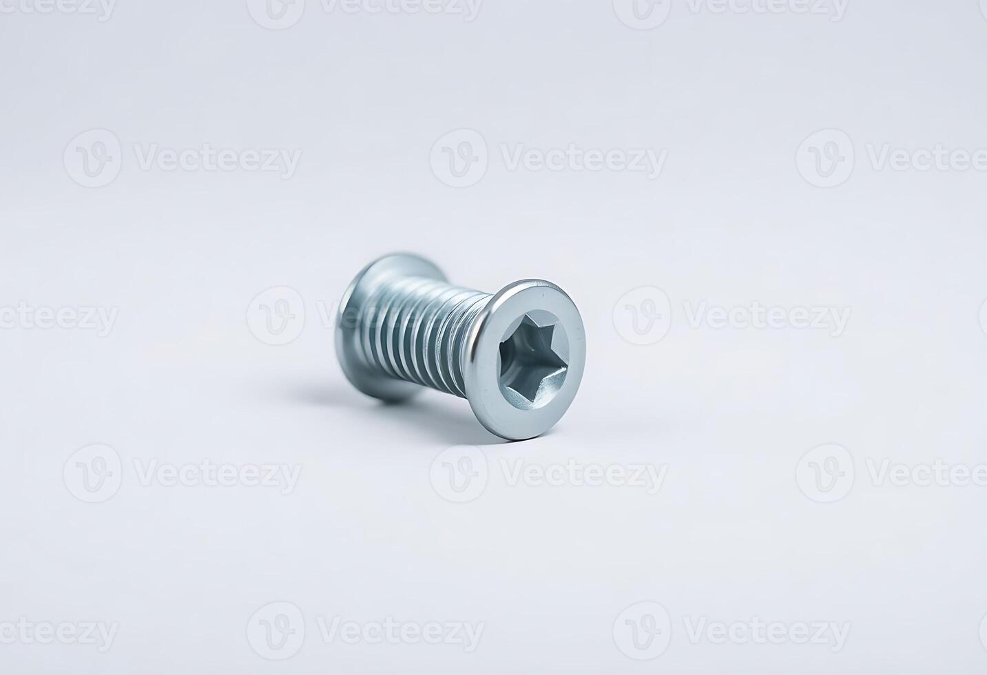 screw on a white surface with a white background photo