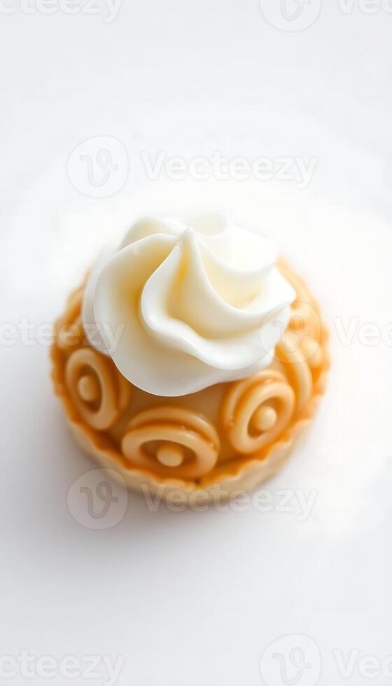 cupcake topped with whipped cream on a white surface photo