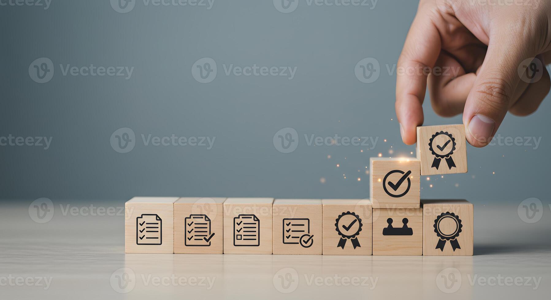 A person is placing wooden blocks with icons on them photo