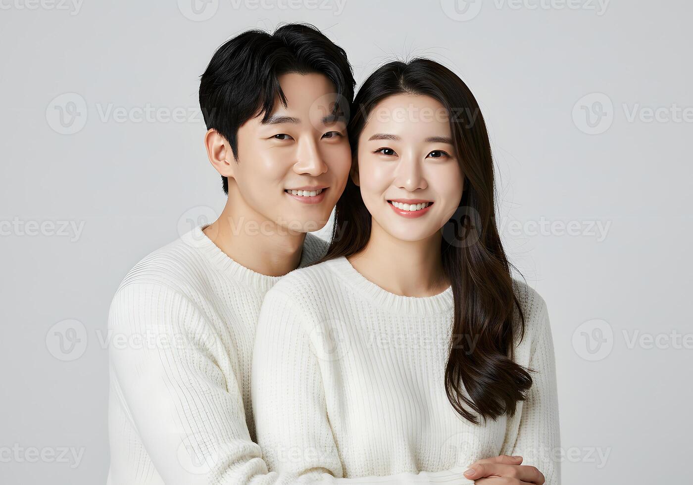 A young couple posing for a photo in white