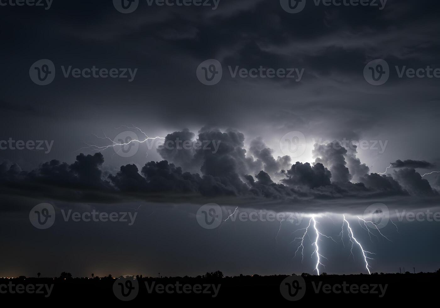 A lightning bolt strikes through the clouds over a dark sky photo