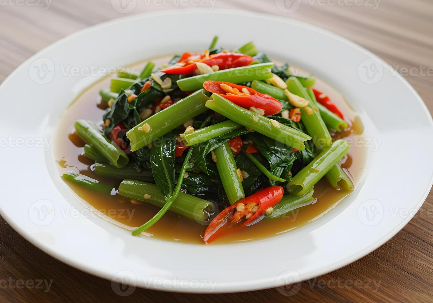 A plate of green beans and peppers on a table photo