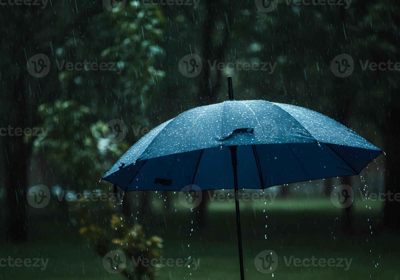 An umbrella is open in the rain photo