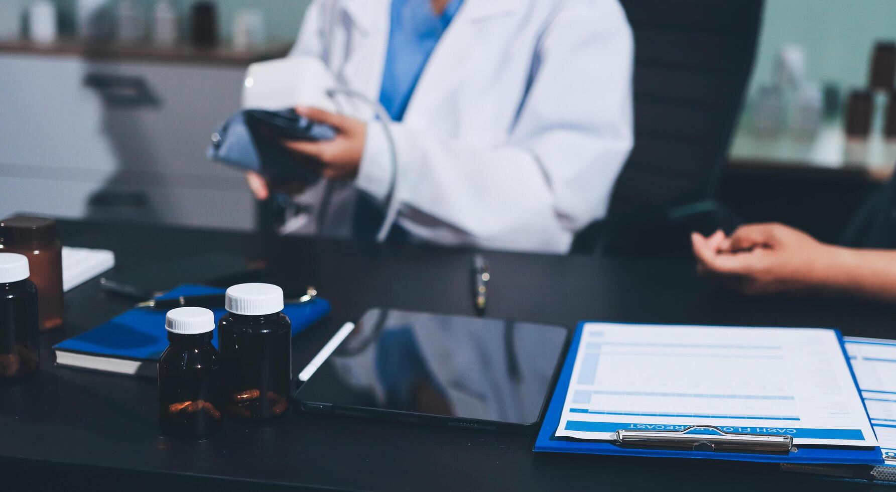 A doctor is holding a clipboard and looking at a bottle photo