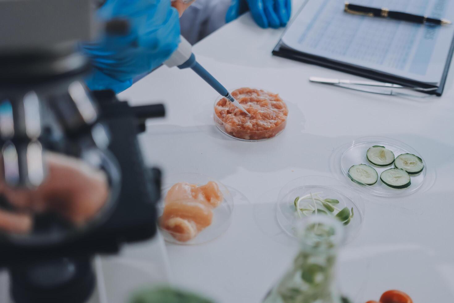 A person in a lab coat is using a microscope to look at food photo