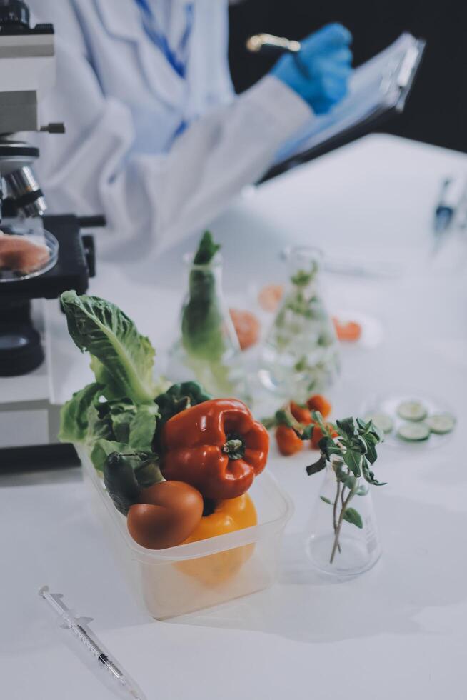 A scientist is working on a project with vegetables photo