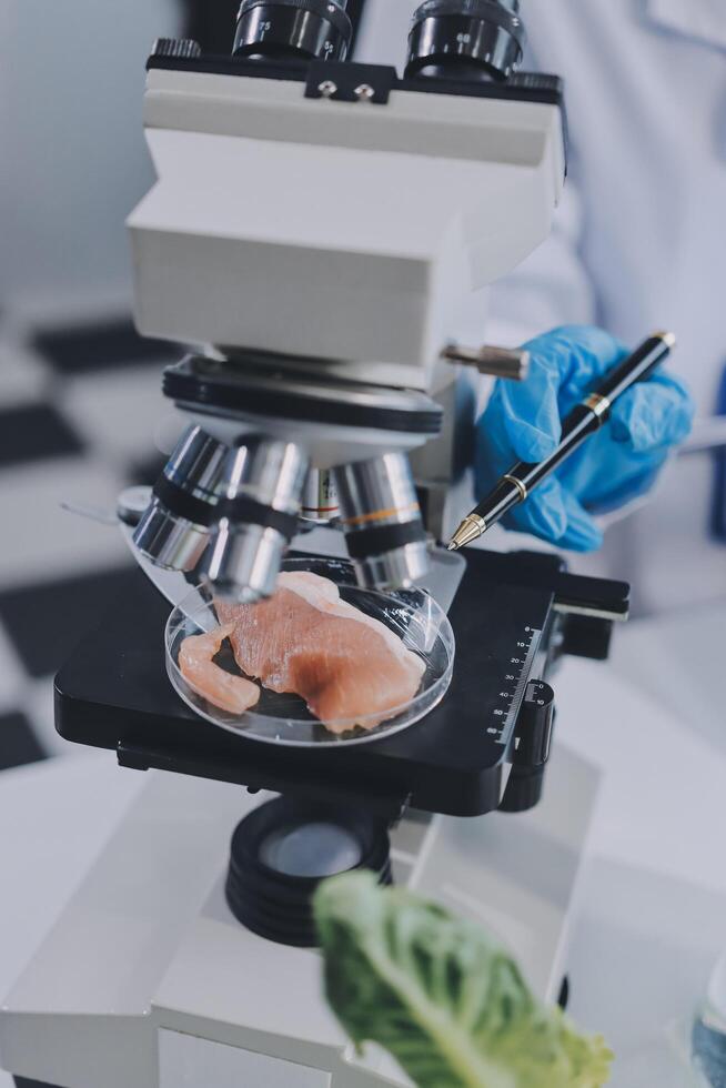 A person in a lab coat is looking at a fish photo