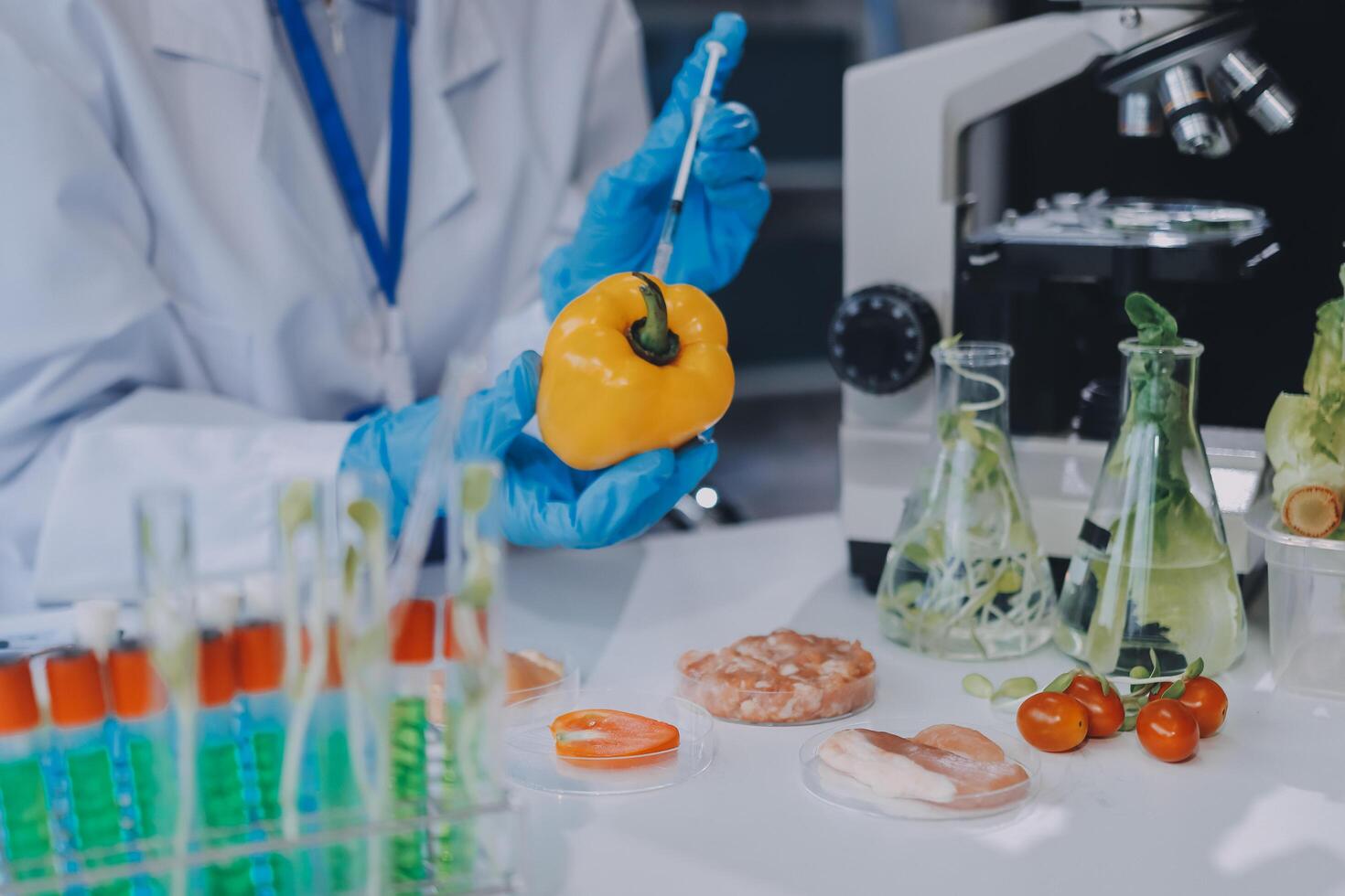 A person in a lab coat is holding a pepper photo