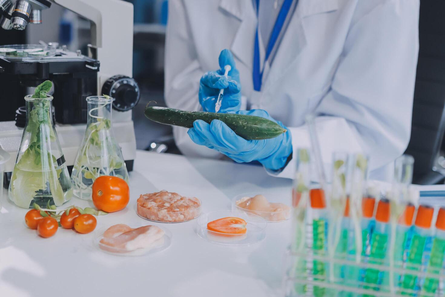 A person in a lab coat is holding a cucumber photo