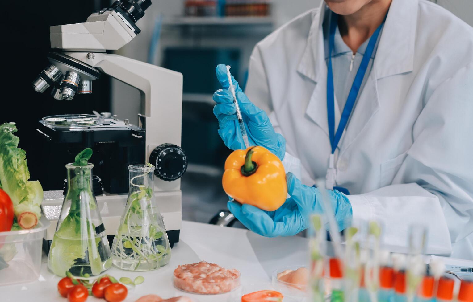 A woman in a lab coat is holding a pepper photo