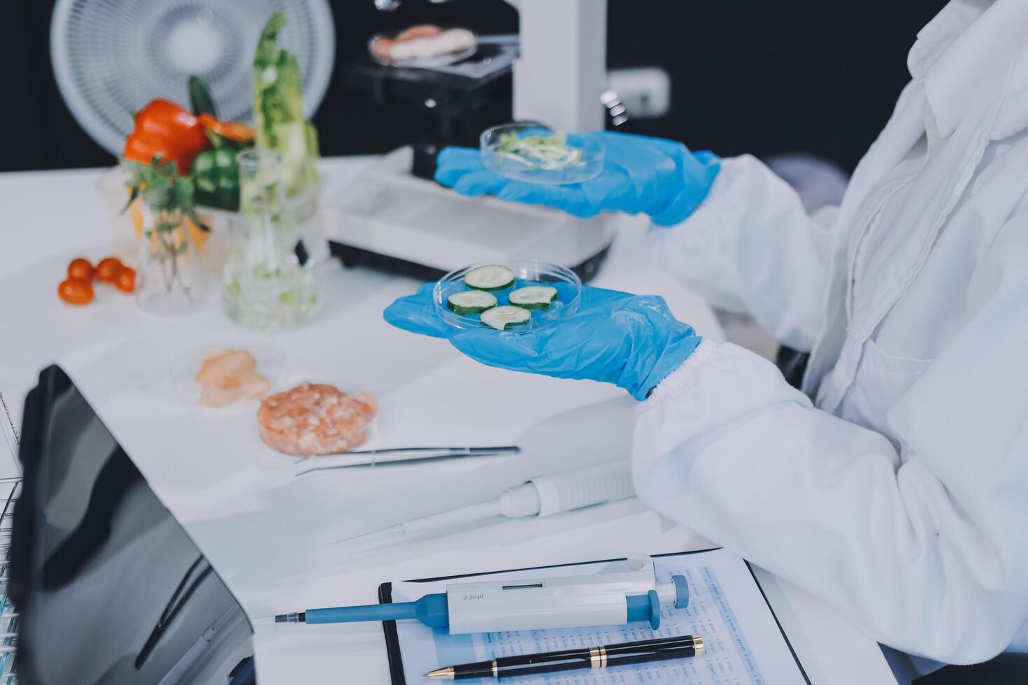 A person in a lab coat holding a microscope photo