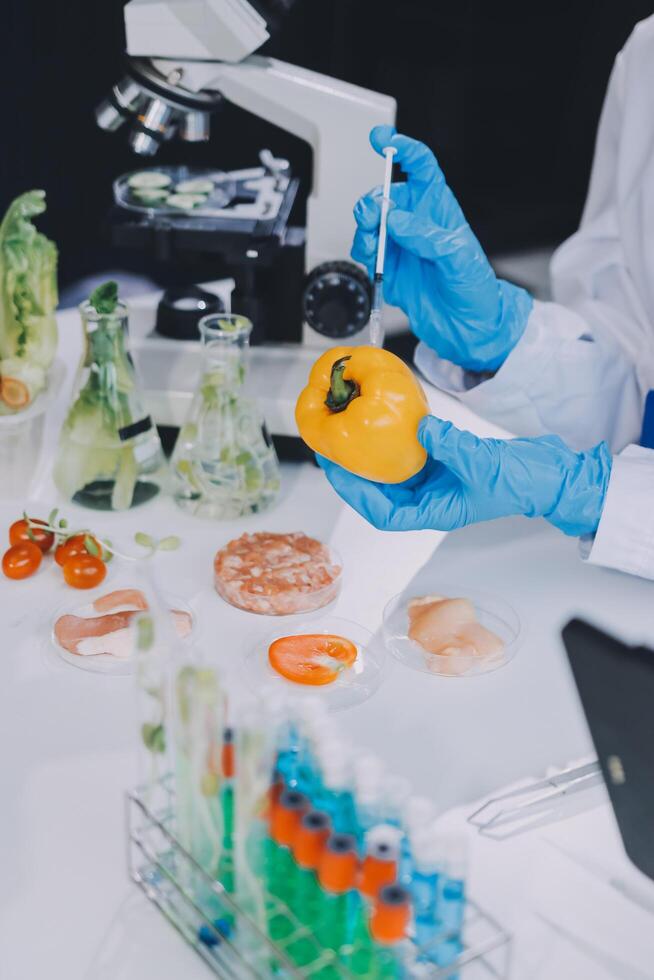 A person in a lab coat holding a food sample photo