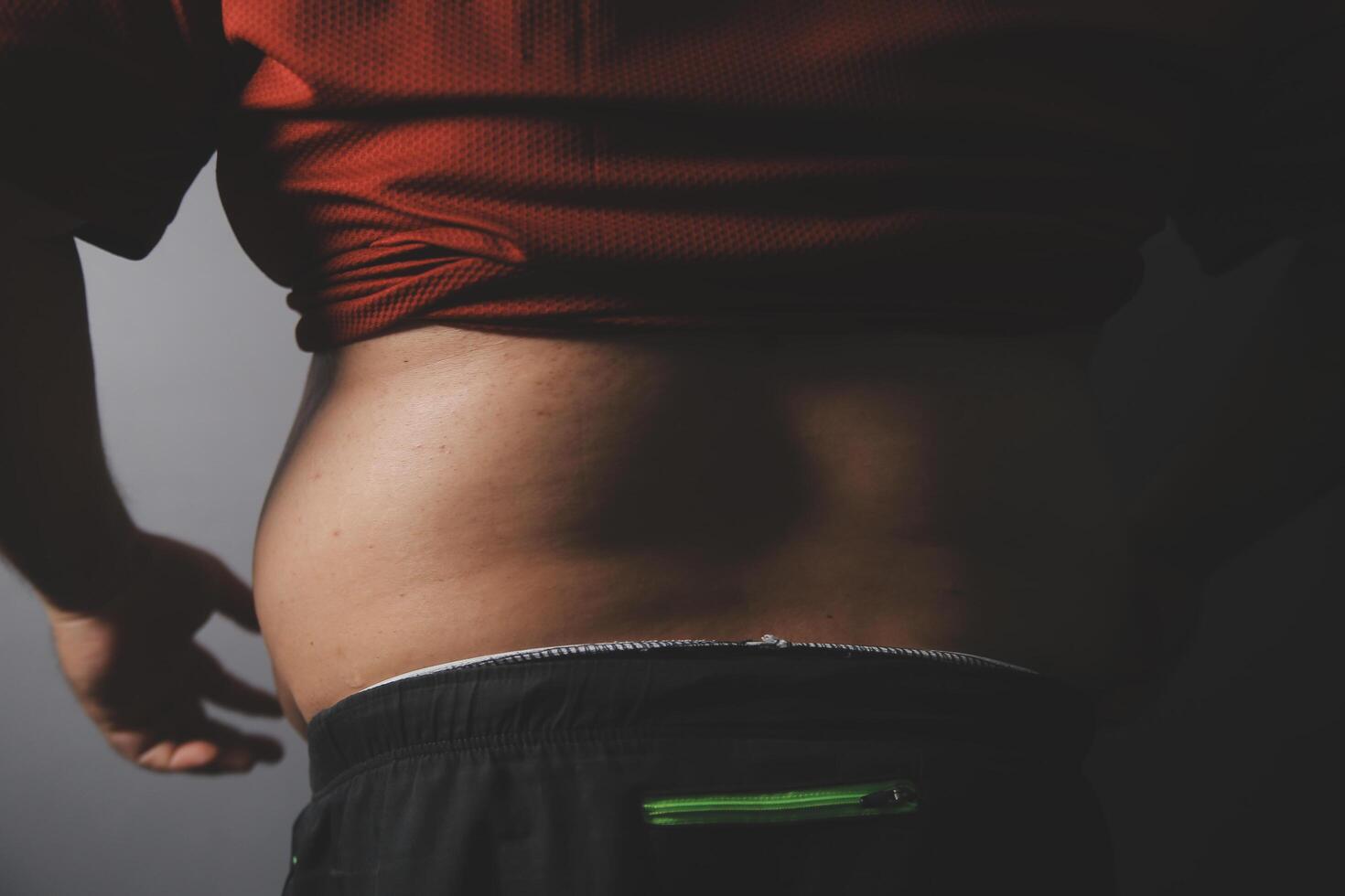 A man with a red shirt on his stomach photo