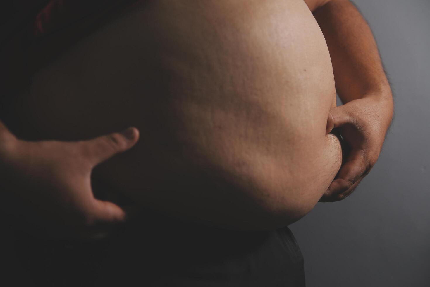 A man with a big belly on his chest photo