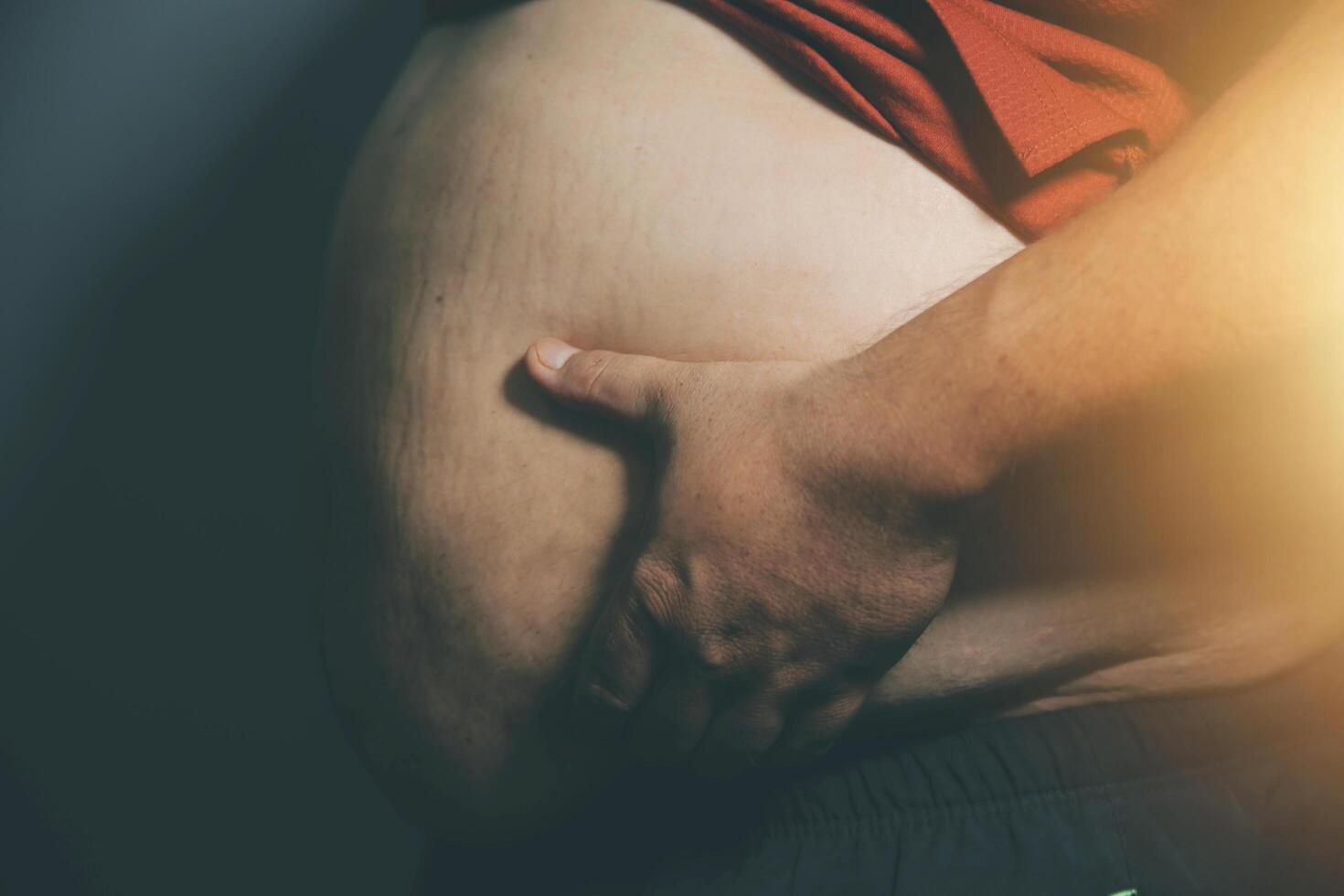 A man with a big belly on his stomach photo