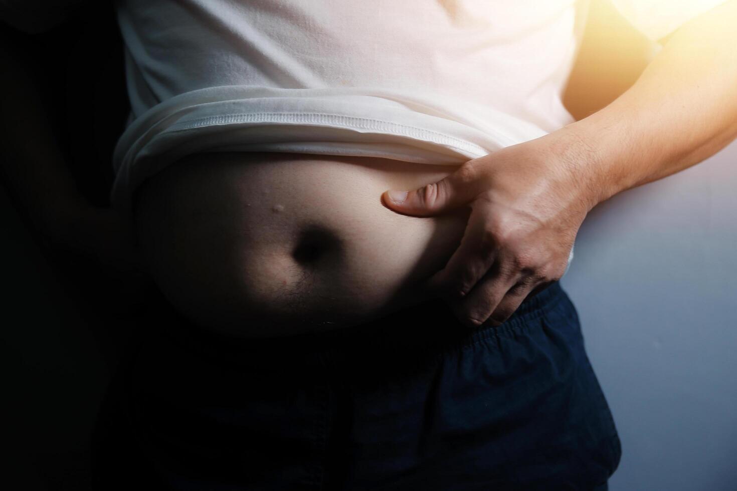 A man with a belly showing off his belly photo