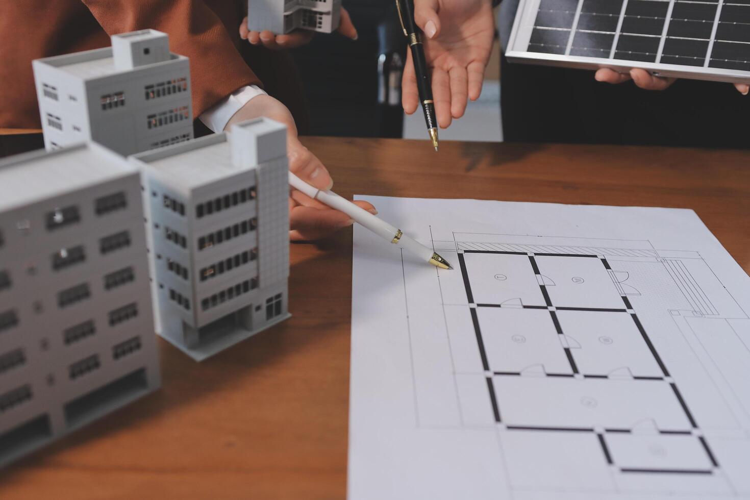 A group of people are working on a building model photo