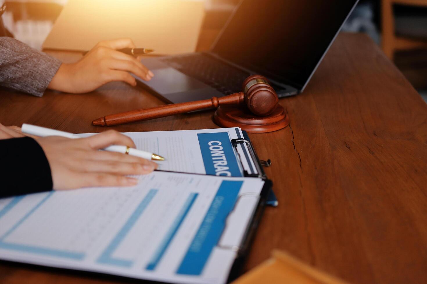 Lawyer and client at the table with documents and laptop photo