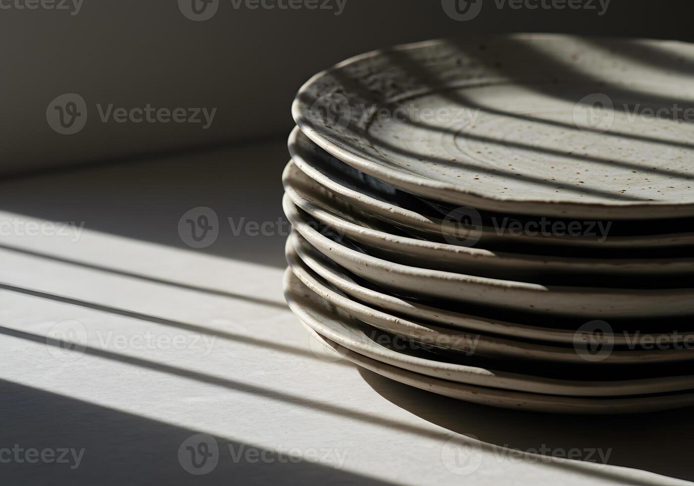 Stack of ceramic plates with shadows for culinary or home design concept photo
