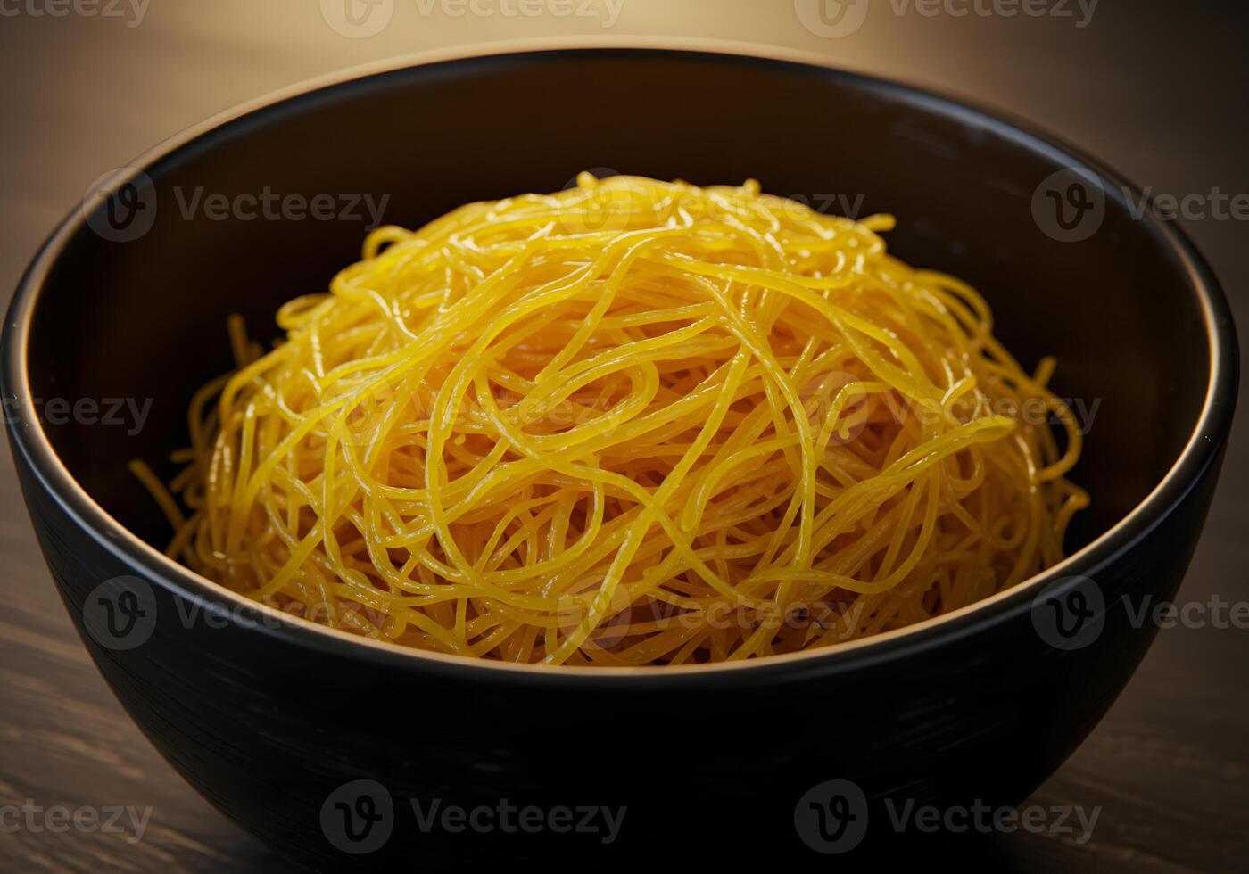 Golden noodles in dark bowl photo