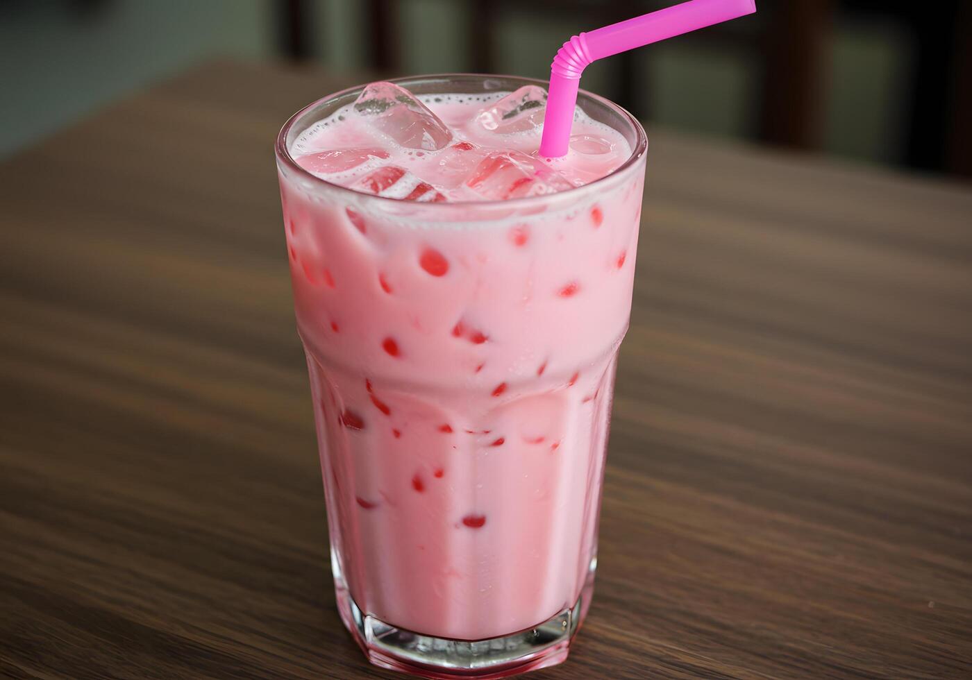 Pink beverage in glass with ice photo