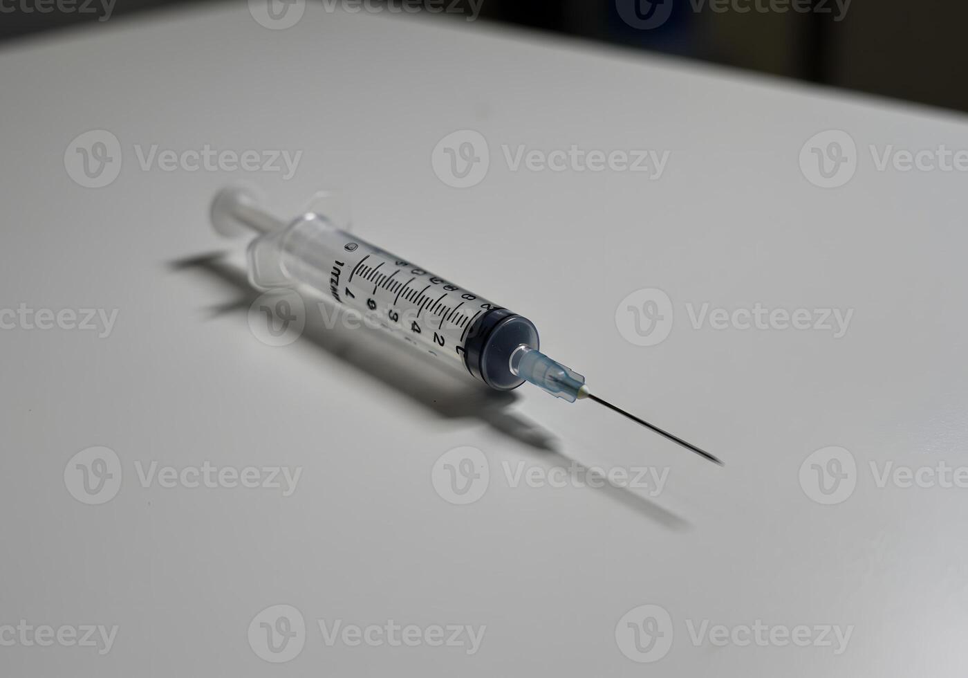 Medical syringe on white surface photo
