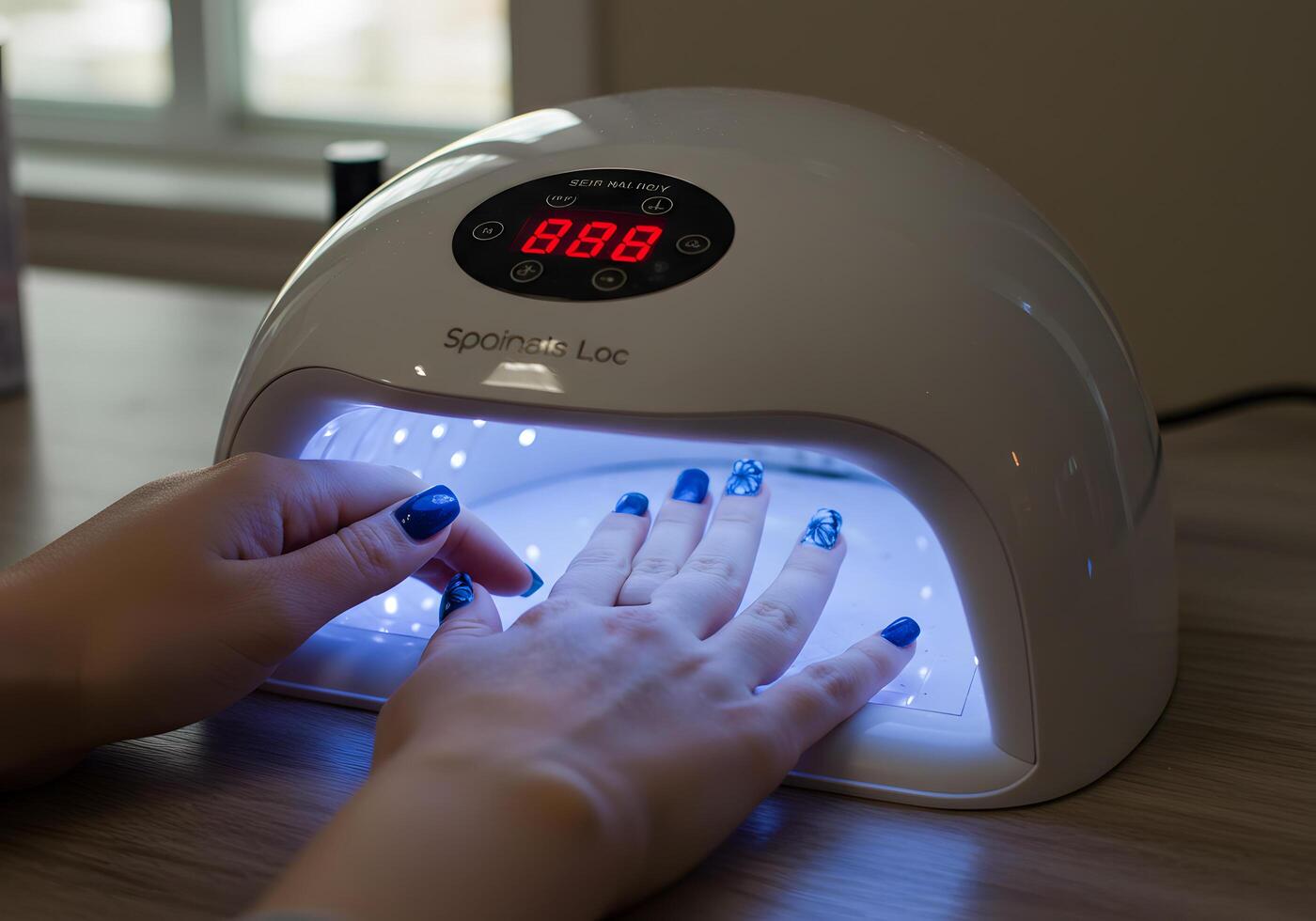 Hands in nail dryer machine photo