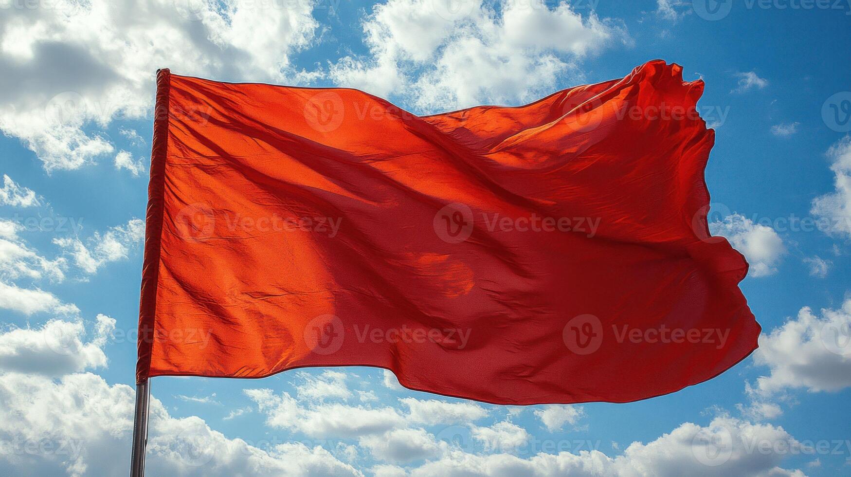 A red flag flying in the wind photo