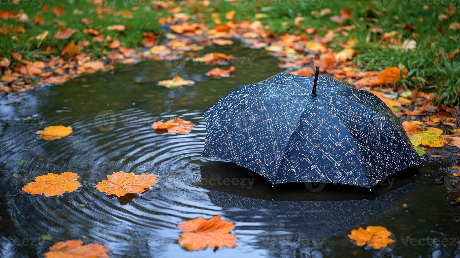 An umbrella is sitting in a puddle of water photo