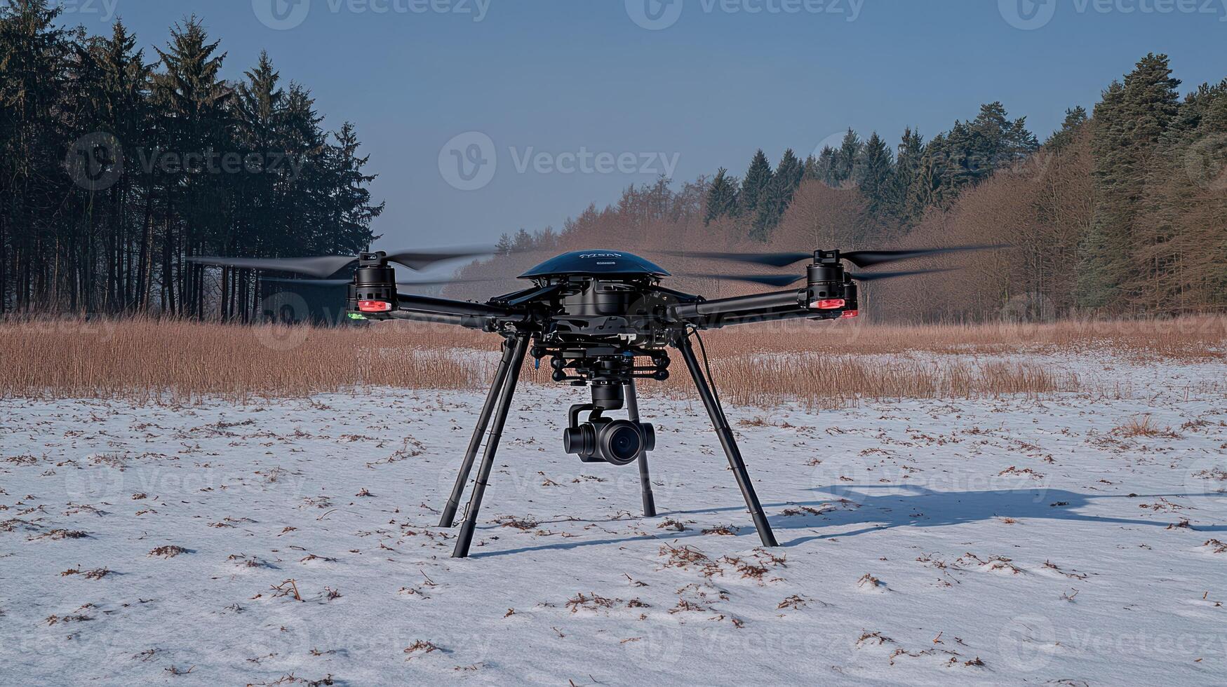 A black drone flying in the snow photo