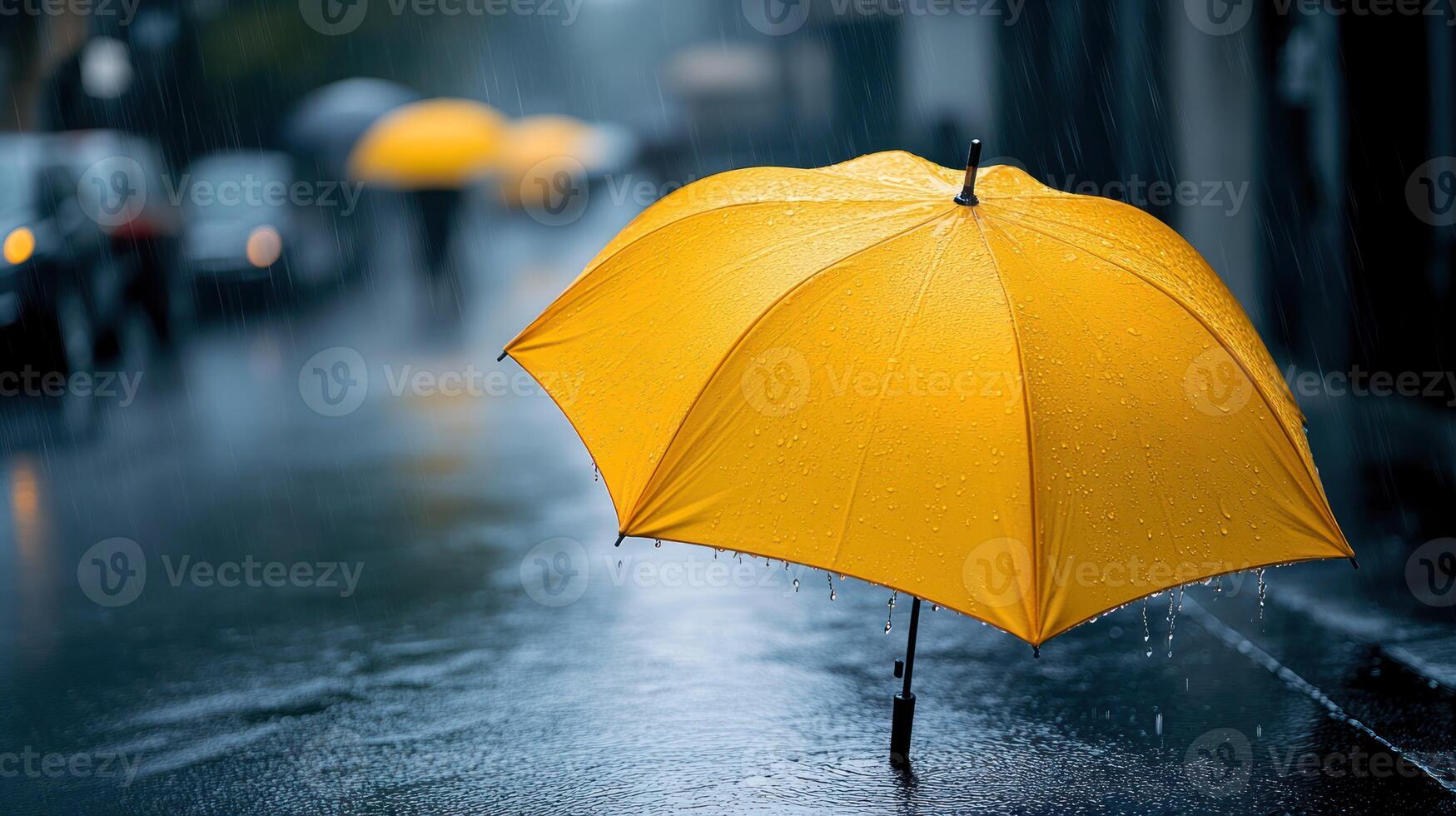 A yellow umbrella in the rain photo
