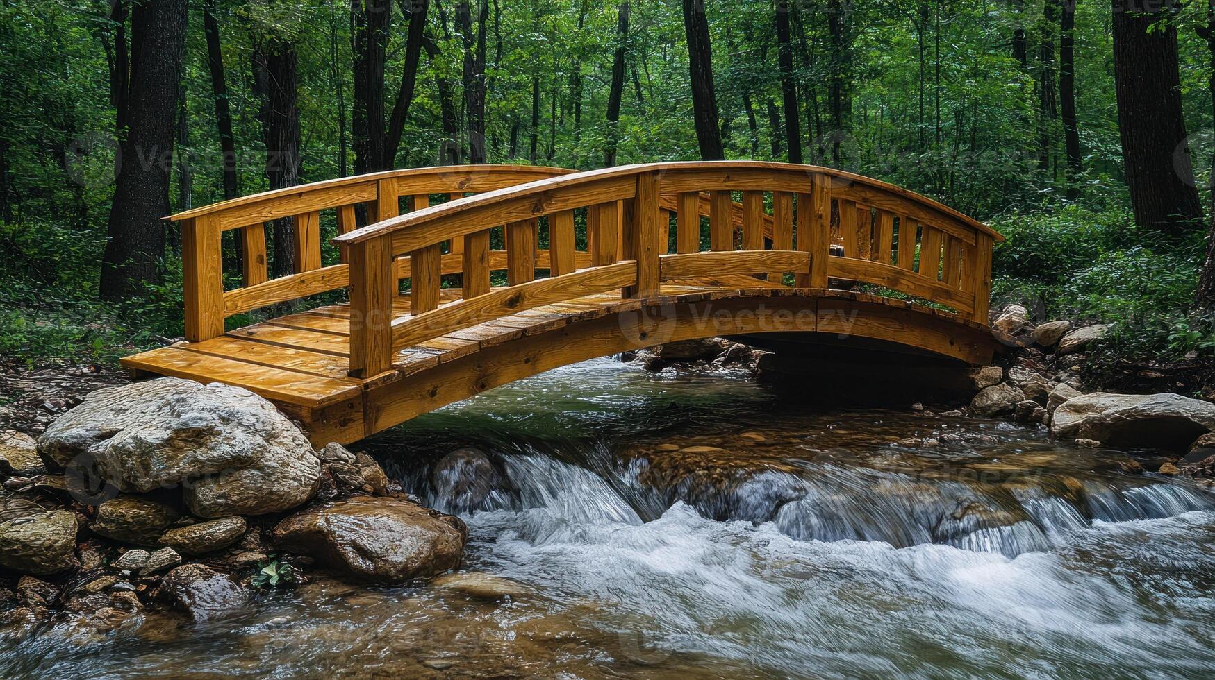 A wooden bridge over a stream in the woods photo