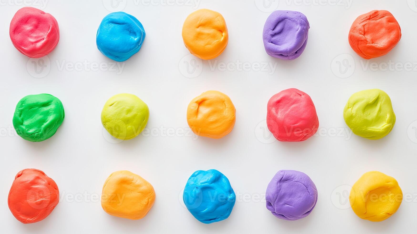 Colorful play dough balls arranged in a circle on a white surface photo