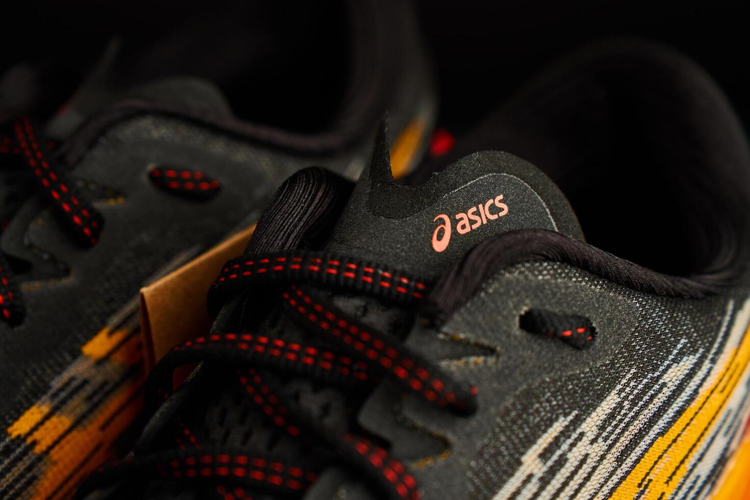 Wroclaw, Poland, 2024 - Close-up of ASICS running shoe with red laces and knit upper photo