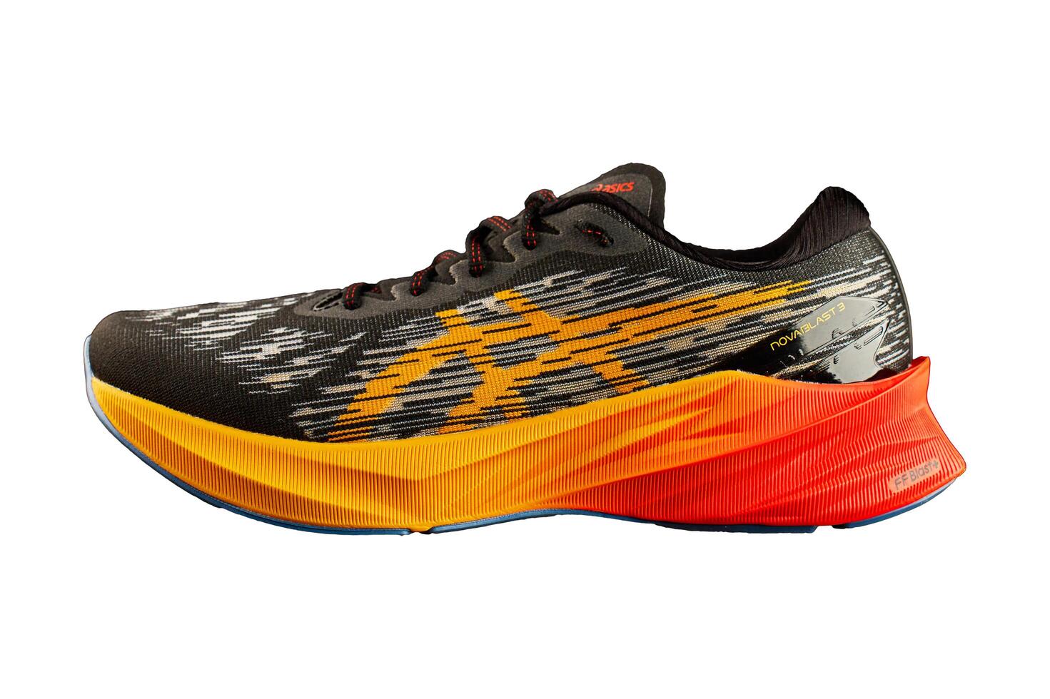Wroclaw, Poland, 2024 - Running shoe with vibrant orange sole isolated photo