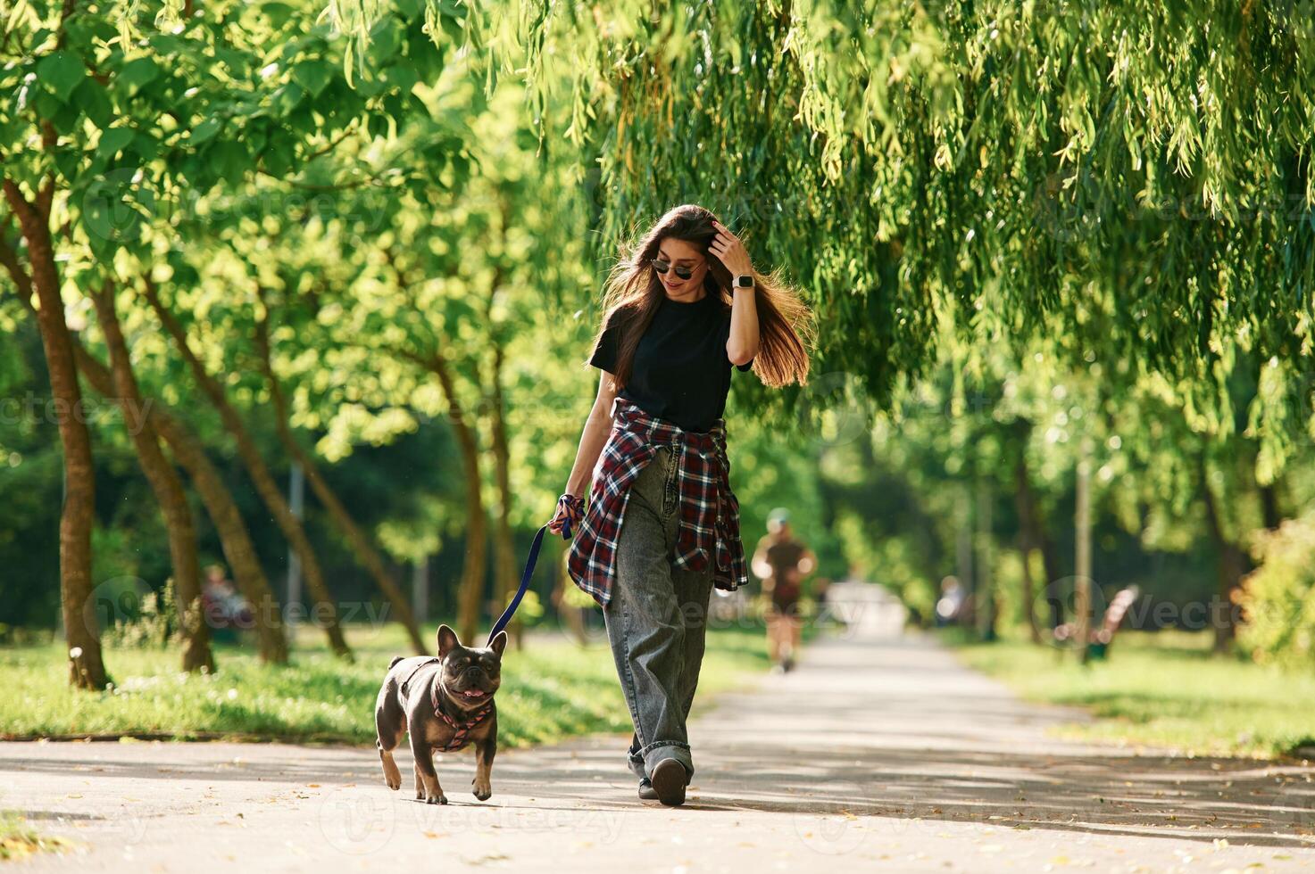 Hawing a walk., Young pretty woman is with her dog in the park photo