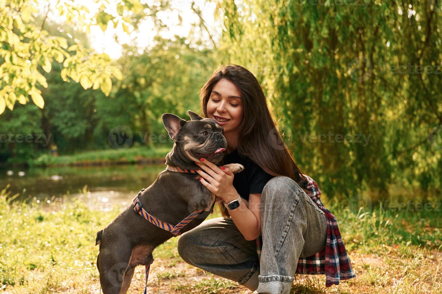 Lovely picture, ,sitting.. Young pretty woman is with her dog in the park photo