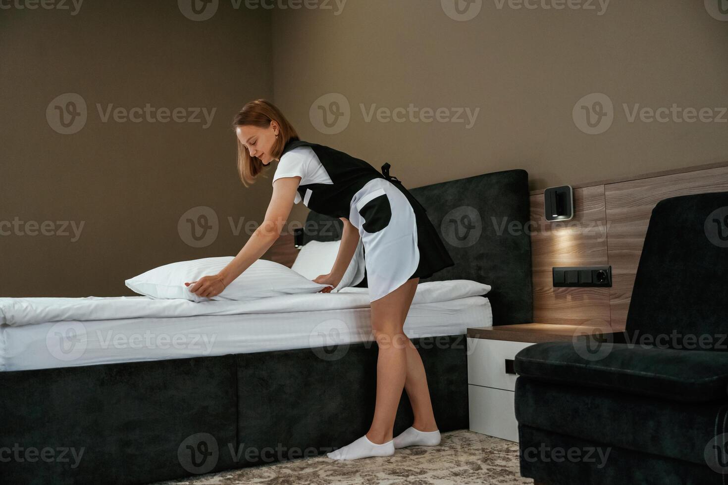 Modern, interior, working. ,.Young chambermaid is in hotel room photo